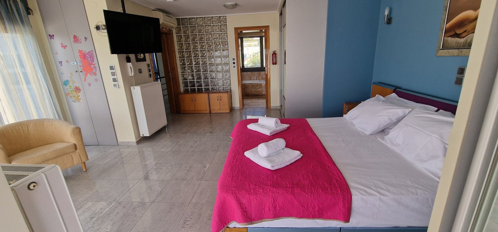 Εσωτερική άποψη υπνοδωματίου στη Villa Memories με καθιστική γωνιά και πρόσβαση σε μπαλκόνι