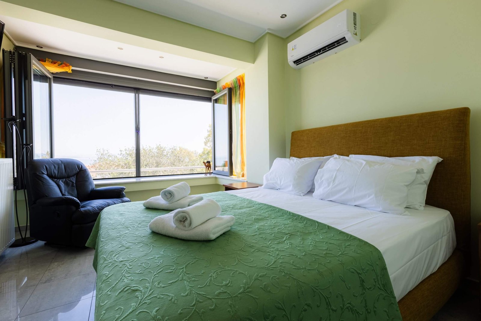 Υπνοδωμάτιο στη Villa Memories στην Κινέτα με διπλό κρεβάτι, πράσινη κουβέρτα και μεγάλο παράθυρο